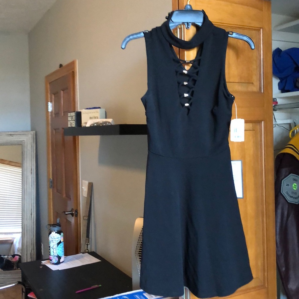 black dress with gold accents, cross tie front
